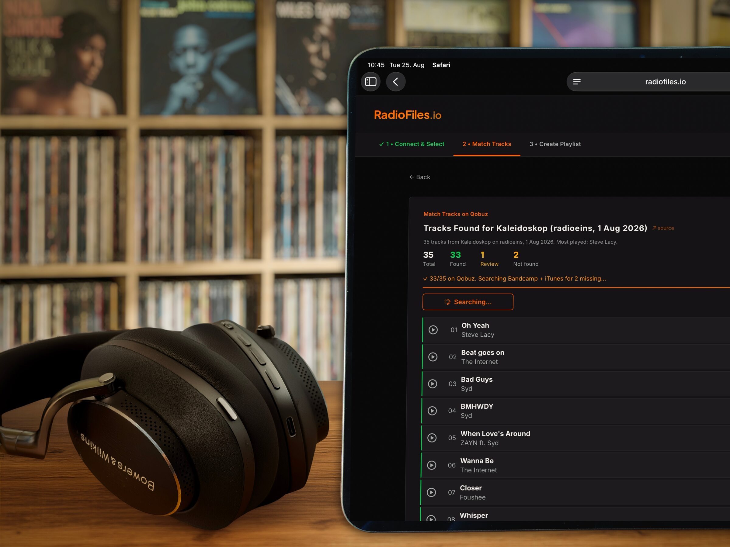 RadioFiles displayed on iPad with vinyl collection and Bowers & Wilkins headphones in foreground
